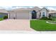 Charming single-story home featuring a well-manicured lawn and a spacious three-car garage at 1057 Sawgrass Dr, Winter Haven, FL 33884