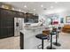 Well-equipped kitchen featuring granite countertops, stainless steel appliances, and breakfast bar seating at 1057 Sawgrass Dr, Winter Haven, FL 33884