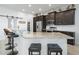 Modern kitchen with stainless steel appliances, granite countertops, and ample bar seating at 1057 Sawgrass Dr, Winter Haven, FL 33884