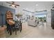 Spacious open-plan living room with tile flooring and a seamless flow to the modern kitchen at 1057 Sawgrass Dr, Winter Haven, FL 33884