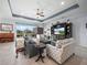 Cozy living room with comfortable seating, a decorative ceiling, and a relaxing atmosphere at 1057 Sawgrass Dr, Winter Haven, FL 33884