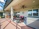 A covered outdoor patio featuring a seating area, ceiling fans, and a hot tub, perfect for relaxing and entertaining at 1057 Sawgrass Dr, Winter Haven, FL 33884