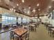 Bright restaurant interior with large windows overlooking a lake, hardwood ceilings, and ample seating for a pleasant dining experience at 1057 Sawgrass Dr, Winter Haven, FL 33884