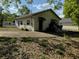 View of rear home with a concrete drive at 1109 Neville Ave, Lakeland, FL 33805