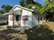 Charming single-story home featuring a covered porch and a well-maintained yard at 1109 Neville Ave, Lakeland, FL 33805