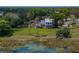 Expansive aerial view showcasing the home's picturesque backyard, lake access and landscaping at 125 E Graham Park Dr, Haines City, FL 33844