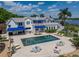 Stunning waterfront home features a spacious pool, outdoor seating, and lush landscaping at 125 E Graham Park Dr, Haines City, FL 33844