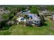A stunning aerial view of the home showcasing the outdoor oasis featuring a pool, spa, and lake views at 125 E Graham Park Dr, Haines City, FL 33844