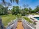 View of a lush backyard featuring a swing set, fountain, and seating area near the inviting pool at 125 E Graham Park Dr, Haines City, FL 33844