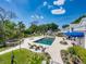 Expansive backyard featuring a large swimming pool, spa, and lush landscaping, perfect for outdoor gatherings at 125 E Graham Park Dr, Haines City, FL 33844