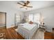 Inviting bedroom with hardwood floors, large windows, a ceiling fan, and a cozy rug at 125 E Graham Park Dr, Haines City, FL 33844
