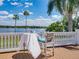 Charming deck with table and chairs, perfect for enjoying the serene lake view and tropical breezes at 125 E Graham Park Dr, Haines City, FL 33844