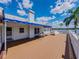 Expansive deck with a seating area overlooks the beautiful lake and tropical landscape at 125 E Graham Park Dr, Haines City, FL 33844