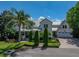 Beautiful two-story home with lush landscaping, a manicured lawn, and charming front porch at 125 E Graham Park Dr, Haines City, FL 33844