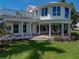 Beautiful home with a wrap-around porch and large windows, offering stunning views and inviting outdoor spaces at 125 E Graham Park Dr, Haines City, FL 33844