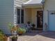 Cozy outdoor seating area at the front entrance with lush plants and a charming statue at 125 E Graham Park Dr, Haines City, FL 33844
