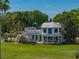 Exterior features a pristine home with a covered porch and immaculate landscaping at 125 E Graham Park Dr, Haines City, FL 33844