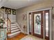 Elegant foyer with hardwood floors, staircase, and decorative glass front door at 125 E Graham Park Dr, Haines City, FL 33844