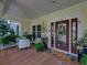 Inviting front porch with seating, potted plants, and a decorated front door with '125' address at 125 E Graham Park Dr, Haines City, FL 33844