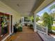 Charming front porch with cozy seating, decorative floral arrangements, and stylish welcome mat at 125 E Graham Park Dr, Haines City, FL 33844