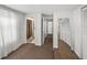 Hallway with carpet floors leading to the bathroom, bedroom, and closet space at 125 E Graham Park Dr, Haines City, FL 33844