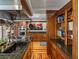 Gourmet kitchen featuring dark wood cabinets, granite countertops, and stainless steel appliances at 125 E Graham Park Dr, Haines City, FL 33844