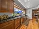 Gourmet kitchen with dark wood cabinets, granite countertops, and window overlooking the garden at 125 E Graham Park Dr, Haines City, FL 33844