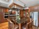 Gourmet kitchen island featuring dark wood cabinets, granite countertops, and stainless steel appliances at 125 E Graham Park Dr, Haines City, FL 33844