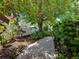 Landscaped yard features a brick walkway and mature trees, providing a serene backyard setting at 125 E Graham Park Dr, Haines City, FL 33844