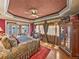 Main bedroom featuring tray ceiling, custom curtains, and lake views at 125 E Graham Park Dr, Haines City, FL 33844