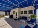 Charming covered patio with comfortable seating and outdoor grill is perfect for entertaining at 125 E Graham Park Dr, Haines City, FL 33844