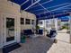 Stylish covered patio includes cozy seating and views of the pool and waterfront at 125 E Graham Park Dr, Haines City, FL 33844