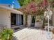 Beautiful patio area features a tiled floor, a white trellis, and colorful bougainvillea at 125 E Graham Park Dr, Haines City, FL 33844