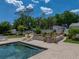 A gorgeous inground pool surrounded by lovely landscaping is ideal for relaxing or entertaining guests at 125 E Graham Park Dr, Haines City, FL 33844