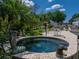 Beautiful outdoor spa featuring an artistic statue and surrounding foliage at 125 E Graham Park Dr, Haines City, FL 33844
