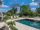 Inviting backyard pool area with lounge chairs and manicured landscaping that will be great for entertaining at 125 E Graham Park Dr, Haines City, FL 33844