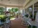 Relaxing outdoor porch featuring comfortable seating, decorative plants, and a charming view of the garden at 125 E Graham Park Dr, Haines City, FL 33844