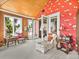 Sitting room featuring vaulted ceilings, colorful wallpaper, and outdoor views at 125 E Graham Park Dr, Haines City, FL 33844