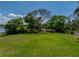 Expansive green lawn with mature trees, offering a tranquil outdoor space for recreation and relaxation at 125 E Graham Park Dr, Haines City, FL 33844