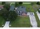 Stunning aerial view of the property showcasing a well-maintained home, lush landscaping, and ample parking at 1403 Hidden Creek Ln, Winter Haven, FL 33880