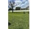 Expansive backyard featuring lush green grass, bordered by a white fence for privacy and security at 1403 Hidden Creek Ln, Winter Haven, FL 33880