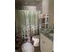 Well-lit bathroom with a decorative shower curtain and essential toiletries at 1403 Hidden Creek Ln, Winter Haven, FL 33880