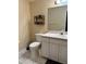 Bathroom featuring a white vanity, toilet, tile floors, and decorative shelving at 1403 Hidden Creek Ln, Winter Haven, FL 33880