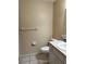 Bathroom with a white vanity, toilet, tile floors, towel bar, and toilet paper holder at 1403 Hidden Creek Ln, Winter Haven, FL 33880