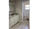 Well-lit bathroom with a vanity featuring a marble countertop, and a separate toilet room at 1403 Hidden Creek Ln, Winter Haven, FL 33880