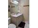 Bathroom with a white vanity, toilet, tile floors, and a large mirror at 1403 Hidden Creek Ln, Winter Haven, FL 33880
