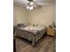 Comfortable bedroom with wood floors, ceiling fan, and natural light at 1403 Hidden Creek Ln, Winter Haven, FL 33880