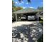 Spacious carport with parking for two vehicles on a sunny day at 1403 Hidden Creek Ln, Winter Haven, FL 33880