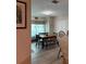 Cozy dining area with a dark wood table, bench, and views of the backyard at 1403 Hidden Creek Ln, Winter Haven, FL 33880