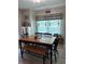 Bright dining room with a large wooden table, bench, and natural lighting at 1403 Hidden Creek Ln, Winter Haven, FL 33880